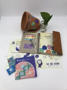 A notebook, planter, and set of materials